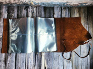 Artistic touch by Tylir Wisdom in this customizable scrapbook with a personalized leather cover from Rustic Engravings.