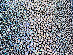  Close-up of luxurious metallic stingray leather in a shimmering silver hue.