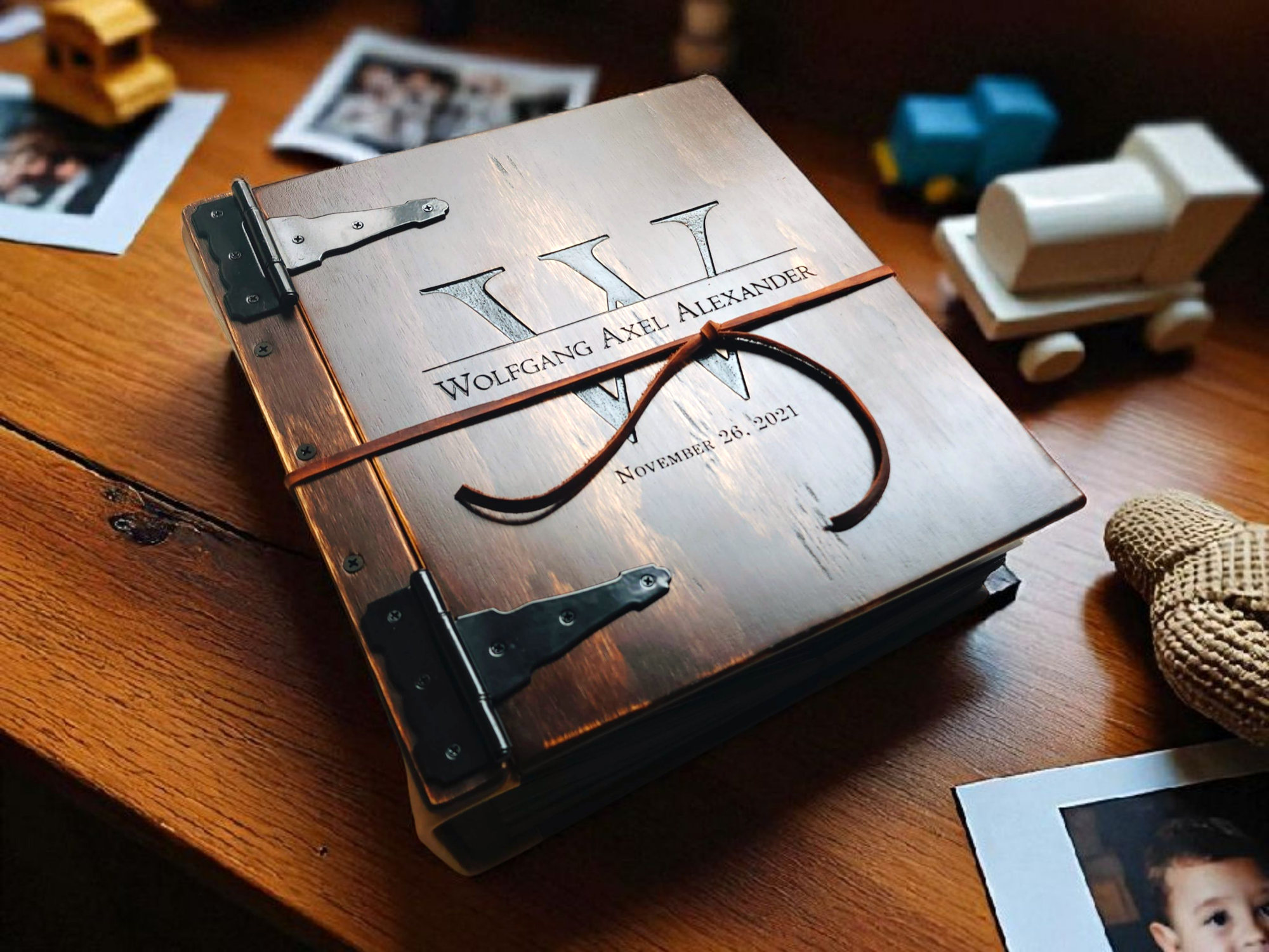 Personalized wooden baby album on a table, perfect for capturing baby memories and milestones.