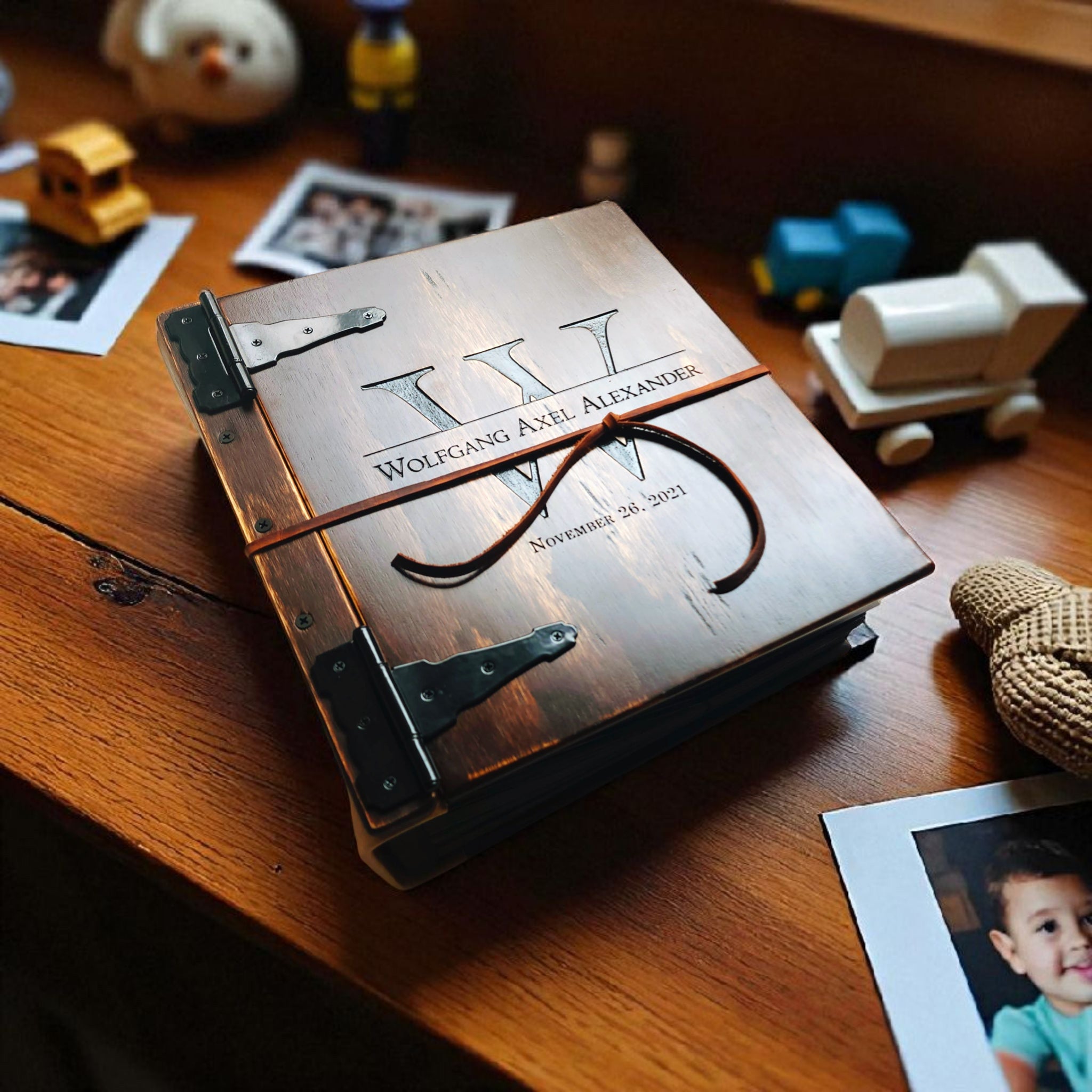 Custom engraved photo album by Rustic Engravings featuring personalized name and date for cherished memories.