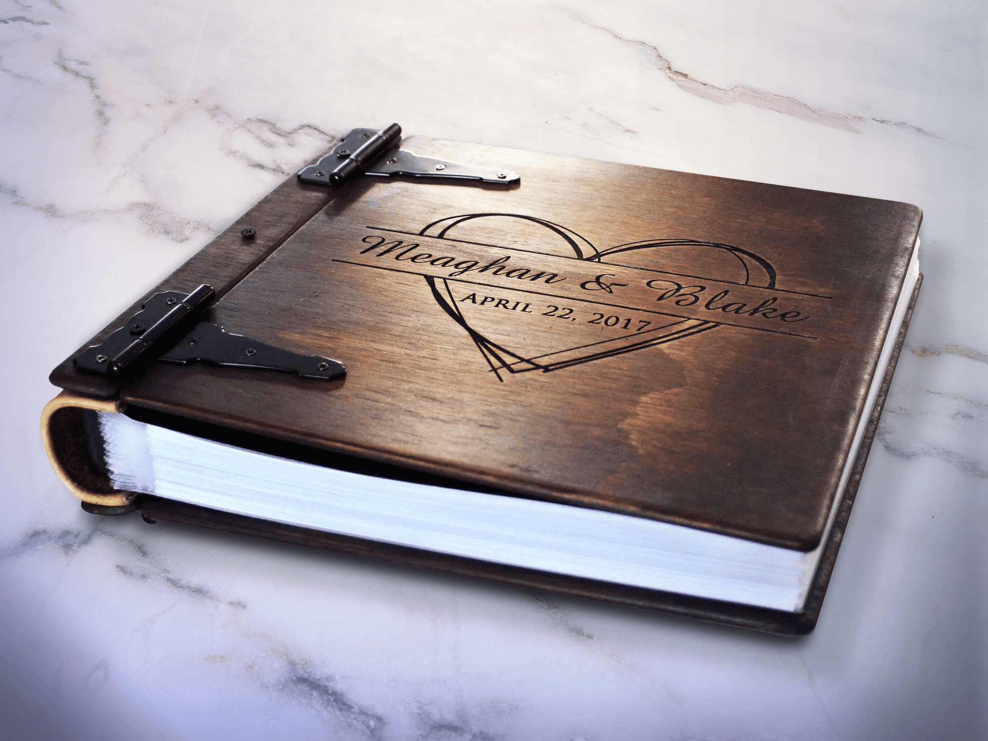 Personalized family photo album by Rustic Engravings |A treasure trove of memories. Each album, crafted by artist Tylir Wisdom, tells your family's story with heartwarming detail. A perfect keepsake for any family, order yours today.
